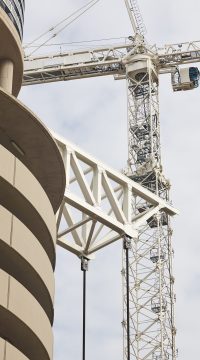 Telescopic cranes under a white sky. Construction engineering industry